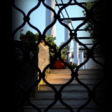 Delle colonne su una scala viste attraverso una grata a Capri